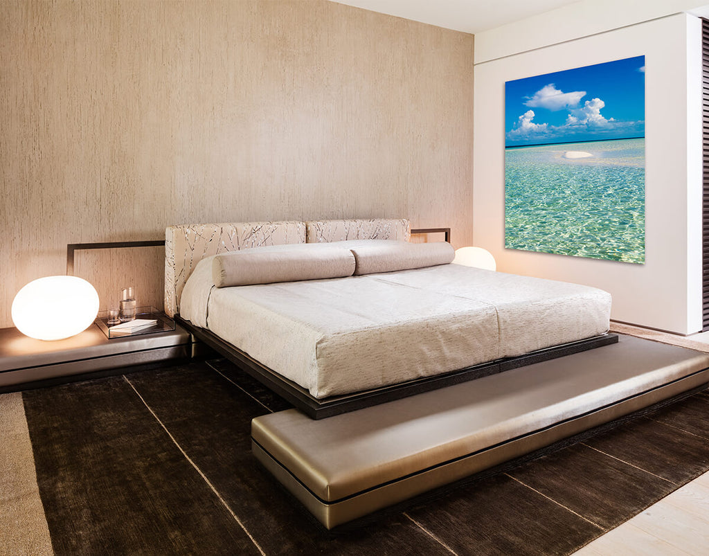 Modern Hollywood Bed bedroom with large bed, ocean-themed artwork, and bedside lamps