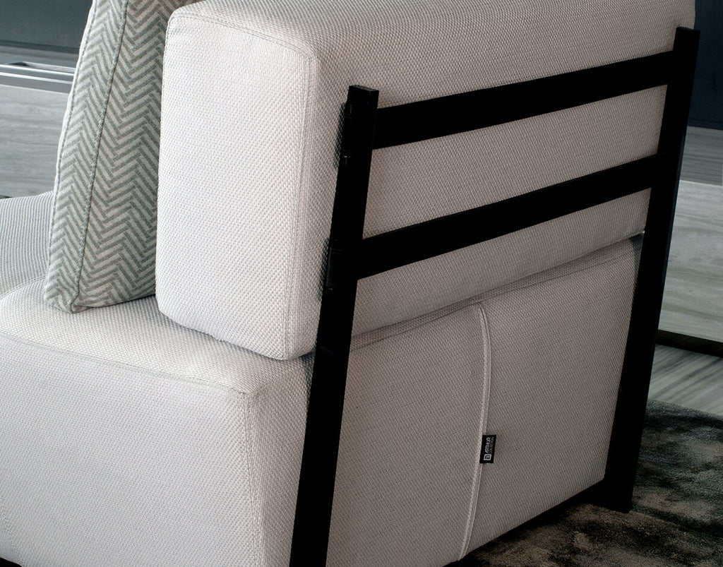 Lucca Chair featuring a light-colored fabric sofa with a sleek black metal frame