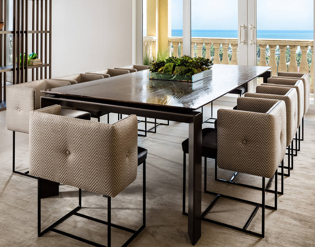 Paris Chair upholstered dining chairs with chevron pattern and button tufting around a dark wood table