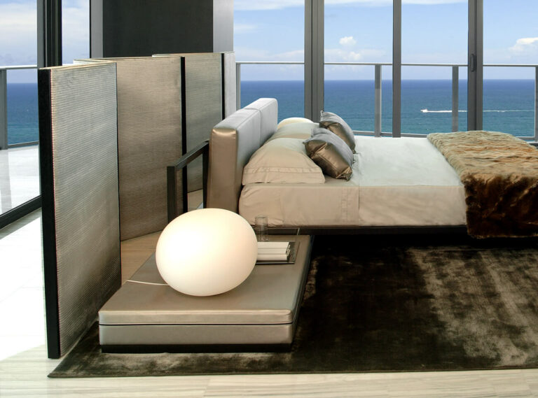 Modern bed with ocean view behind Antwerp Screen for stylish bedroom decor