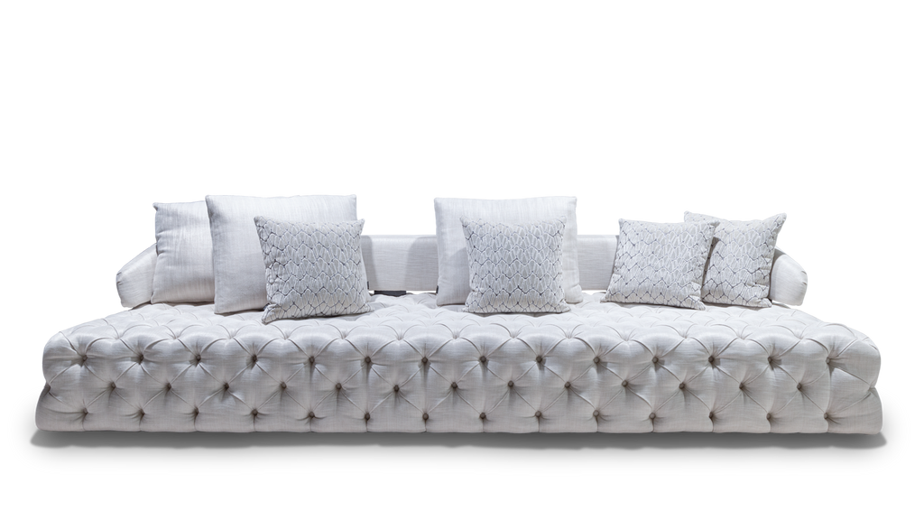 White tufted velvet sofa with decorative pillows showcasing the Versailles Sofa style