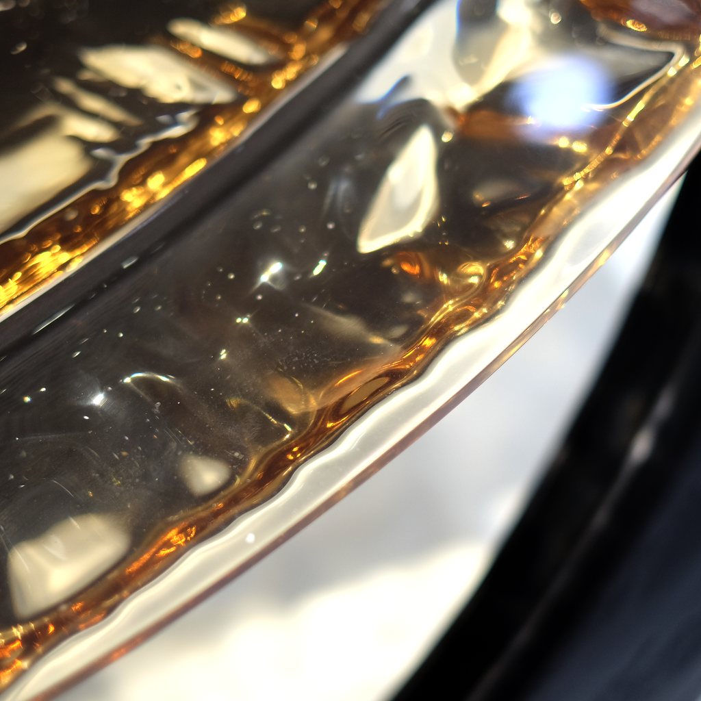 Decorative wavy-edged metallic gold and silver tray on Black Ivy Coffee Table