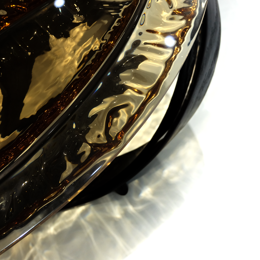 Decorative wavy metallic gold and dark brown bowl on Black Ivy Coffee Table