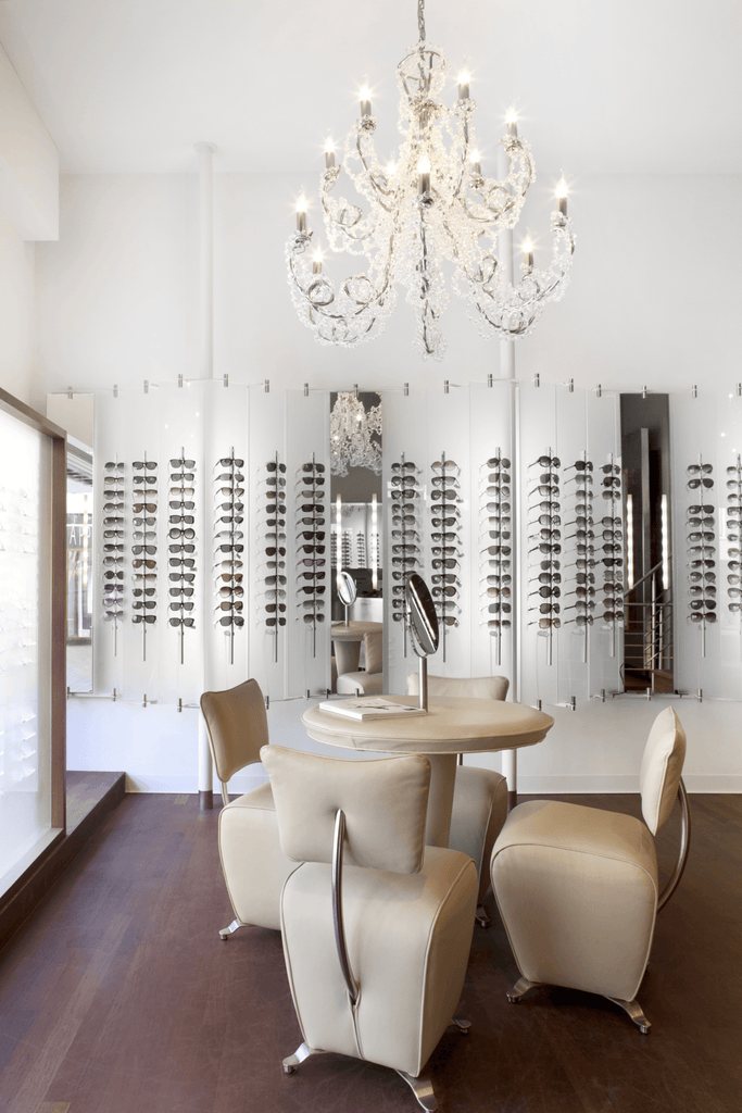 Elegant Coco Chandelier Conical illuminating a sophisticated optical shop with eyeglasses