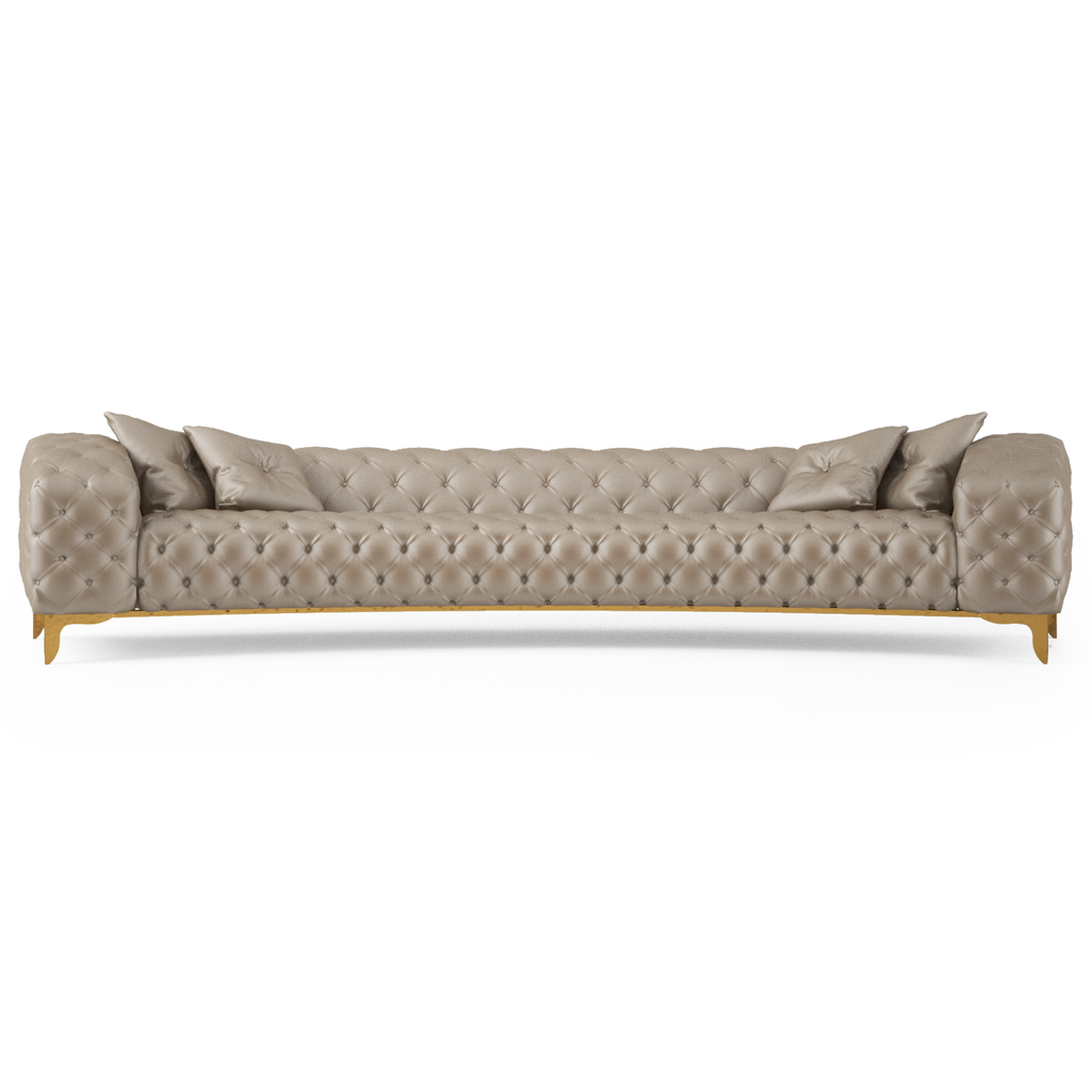 Curved sofa with long tufted beige upholstery, four throw pillows and light brown wooden legs