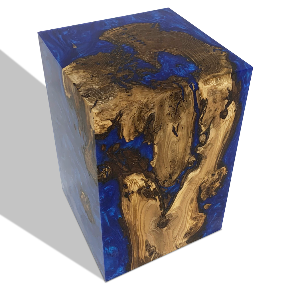 Wooden block encased in blue resin on Dione Pearl Blue End Table for elegant decor