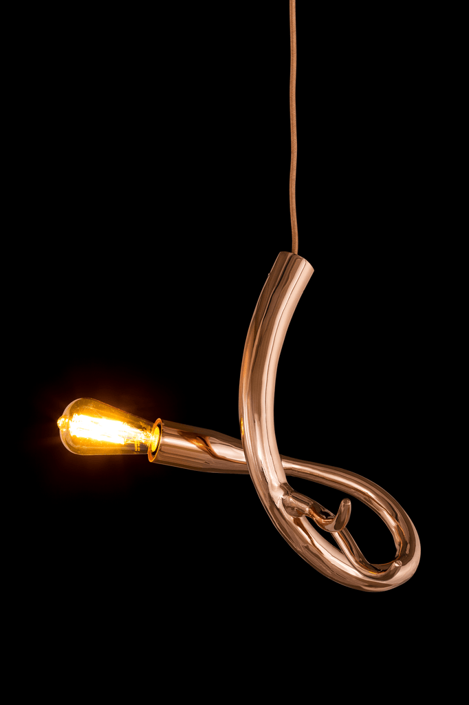 Copper-colored curved pendant light with Edison bulb from Edisons Tail Element 4