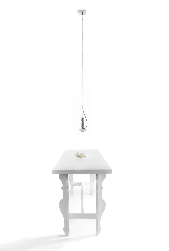 Minimalist white floating candles hanging lamp over matching white table with ornate legs
