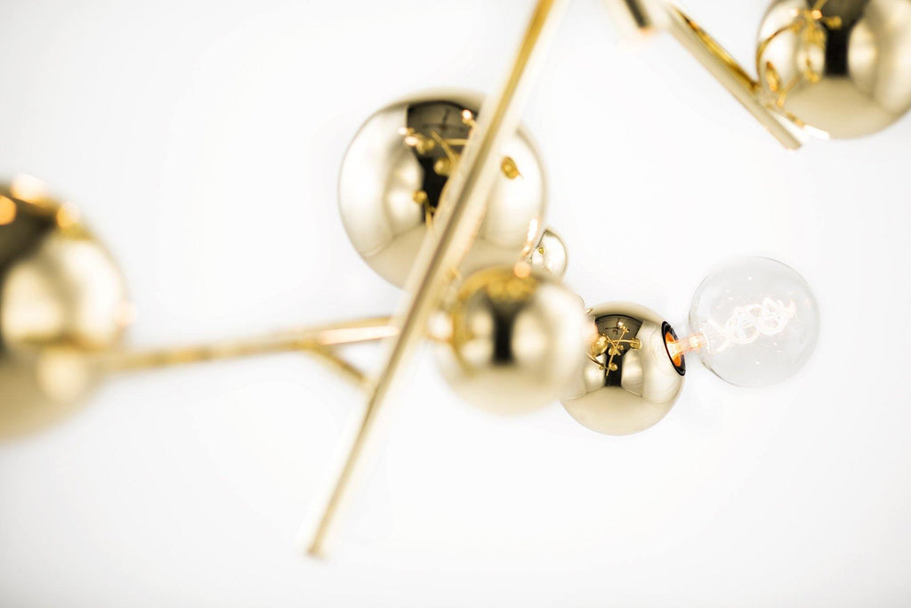 Galaxy Chandelier Round featuring reflective gold spheres and a clear spherical light