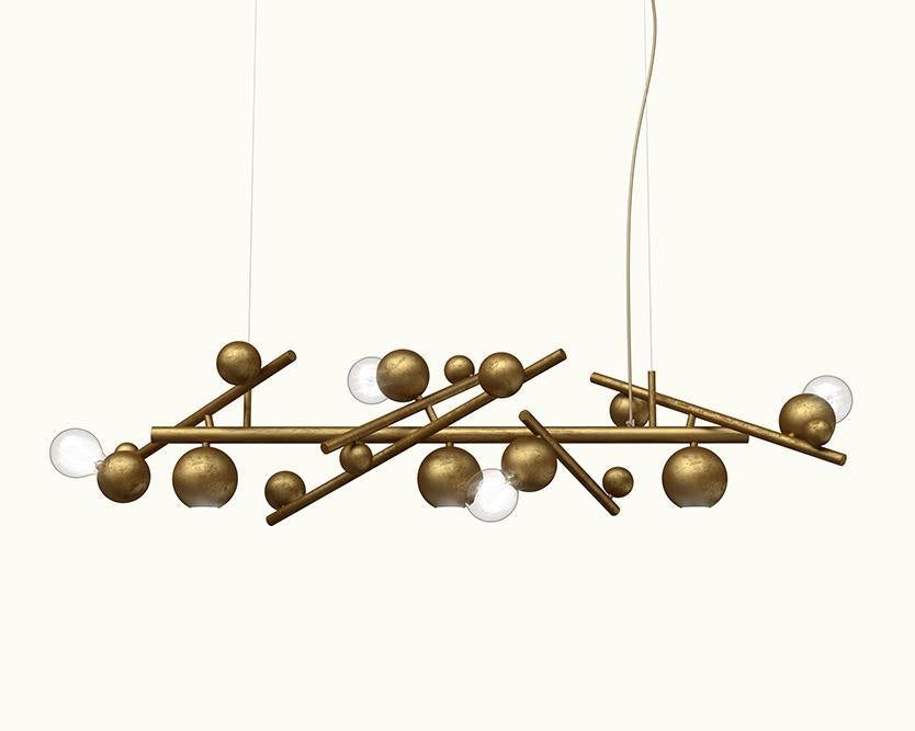 Modern galaxy hanging lamp with brushed brass finish, spherical shades, and glass globes