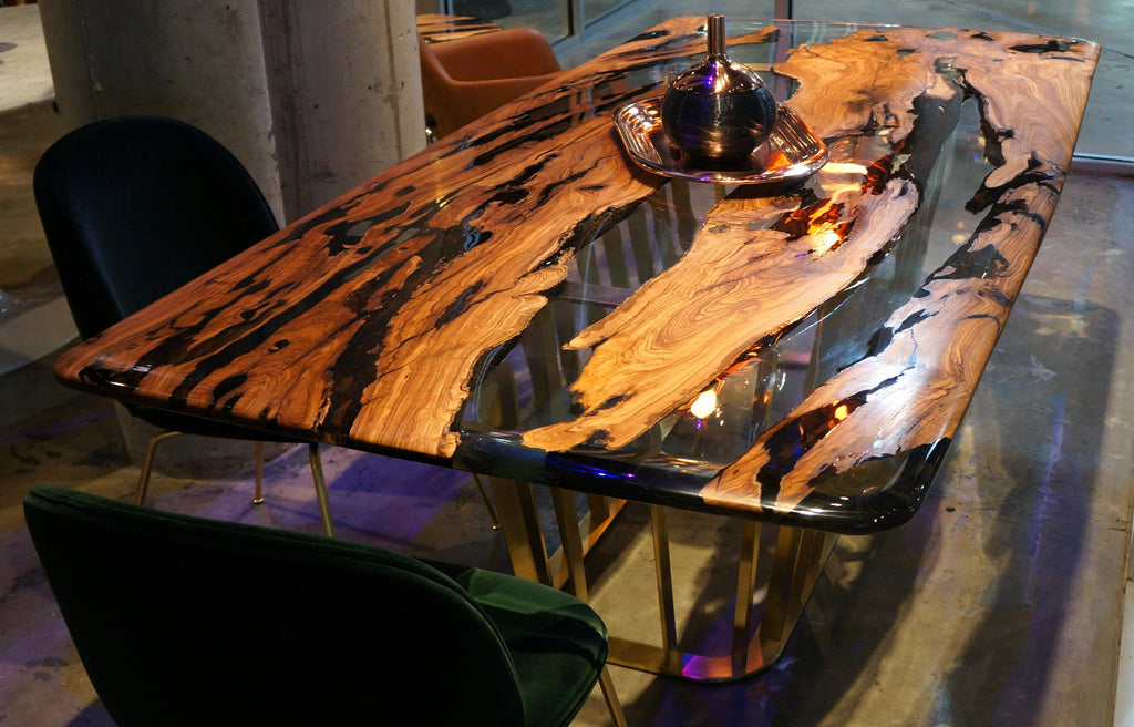 Giona Olive Dining Table with clear resin top, natural wood slabs, black accents, gold legs