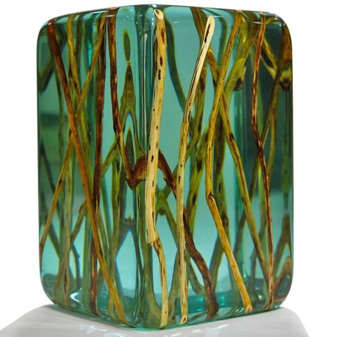 Green branches end table featuring a clear teal resin block with embedded natural branches
