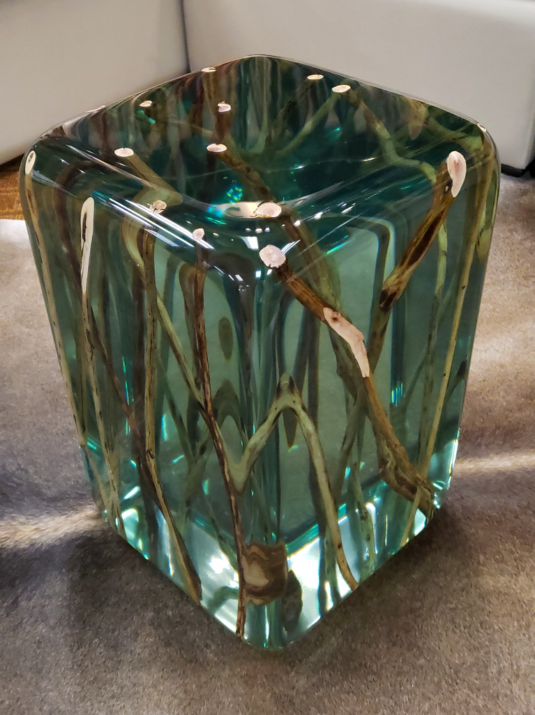 Green branches end table featuring teal resin with embedded natural branches and seashell accents