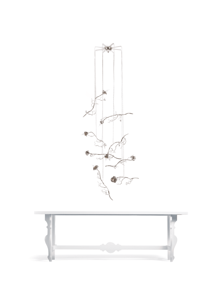White rectangular console table with decorative mobile in La Vie En Rosa Single Light Rose