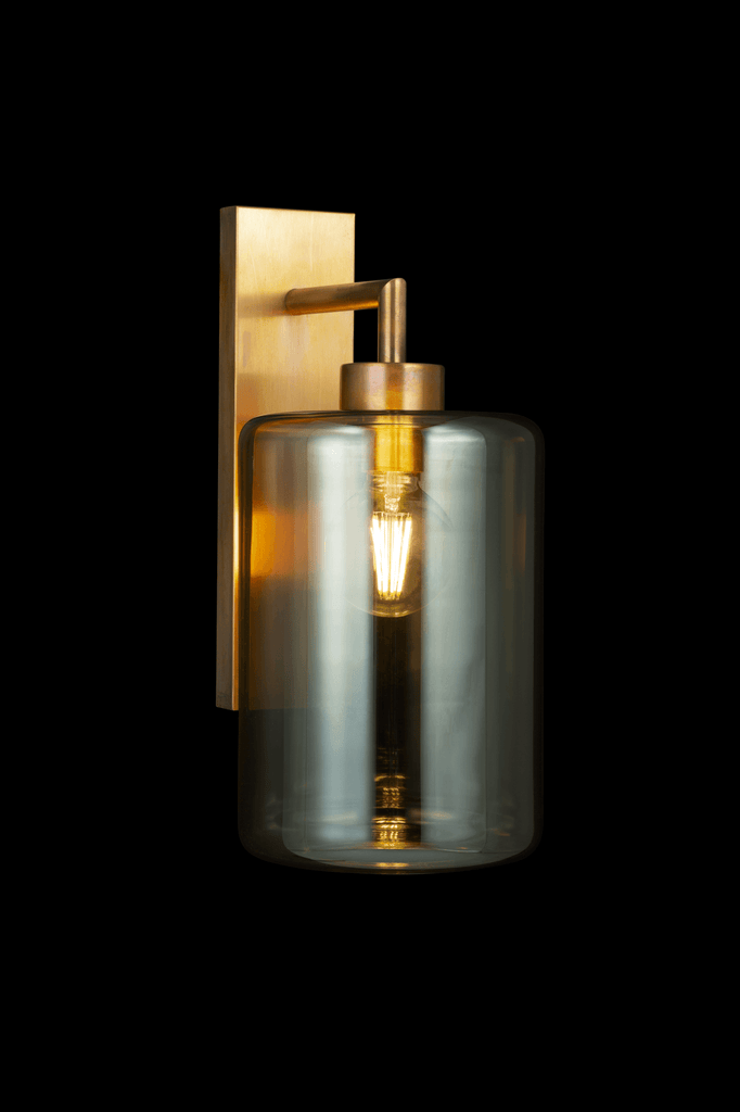 Louise Wall Lamp featuring a brass backplate and smoked glass shade with exposed filament bulb