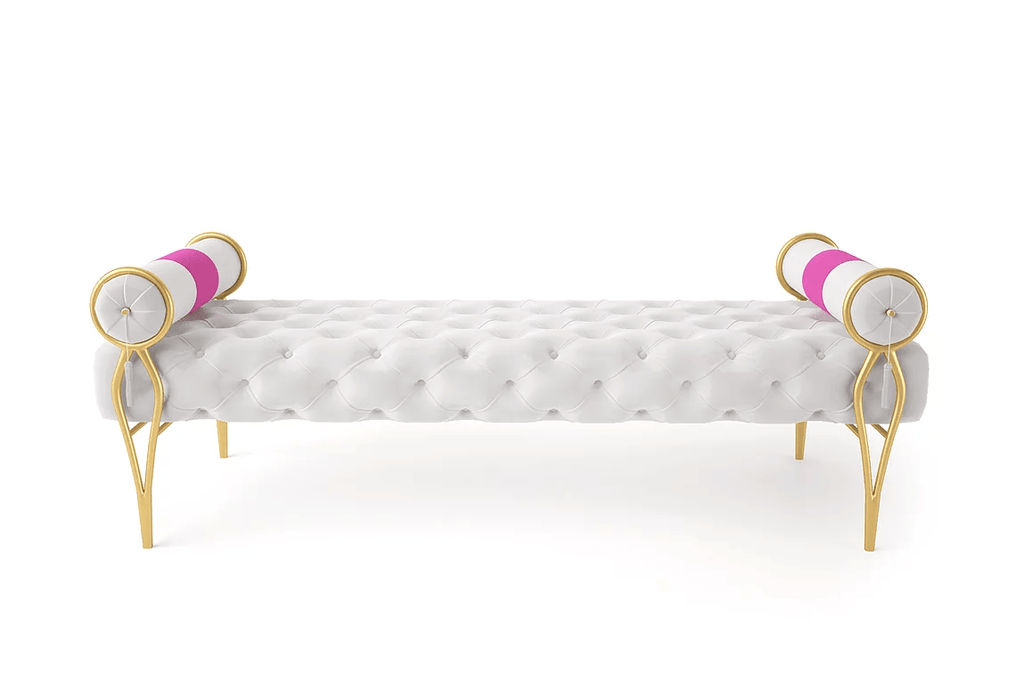 White tufted velvet Merced Bench with gold metal legs and pink white striped bolster pillows