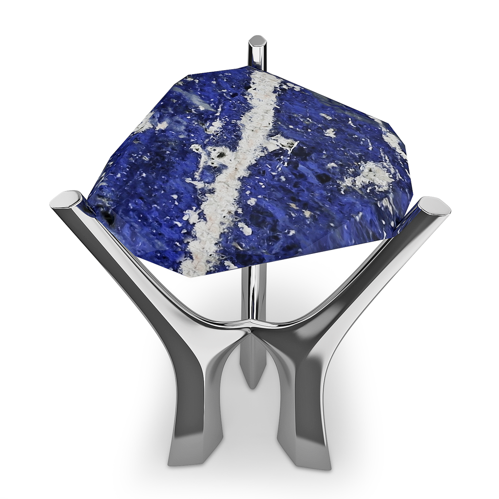 Oval triangle rough-cut blue and white gemstone on polished silver stand at Nisos Side Table