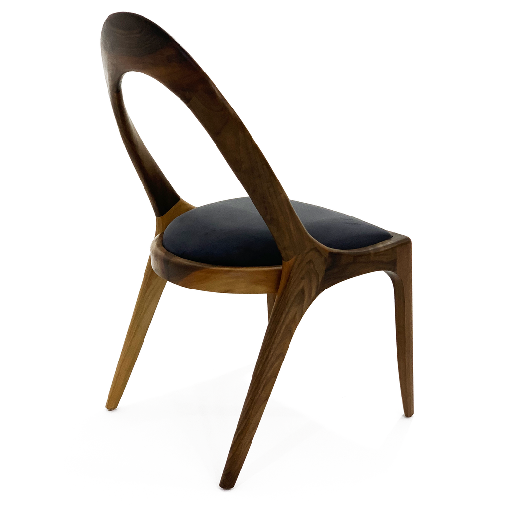 Modern wooden Nyks Dining Chair with dark upholstered seat and curved open back