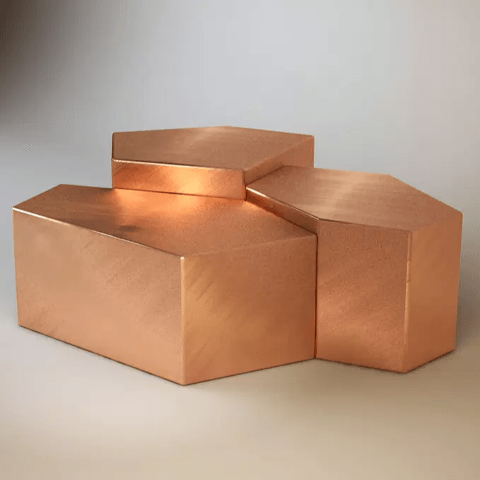 Polished copper-colored hexagonal blocks forming part of the Quarry Cocktail Table design