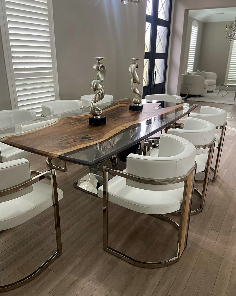 Signature Walnut Dining Table with live-edge wood, resin river, chrome base, and white chairs