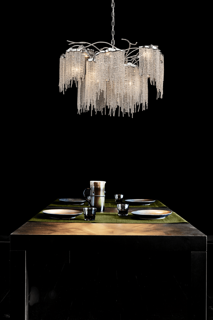 Victoria Chandelier Round hanging above dining table with cascading chains and multiple lights
