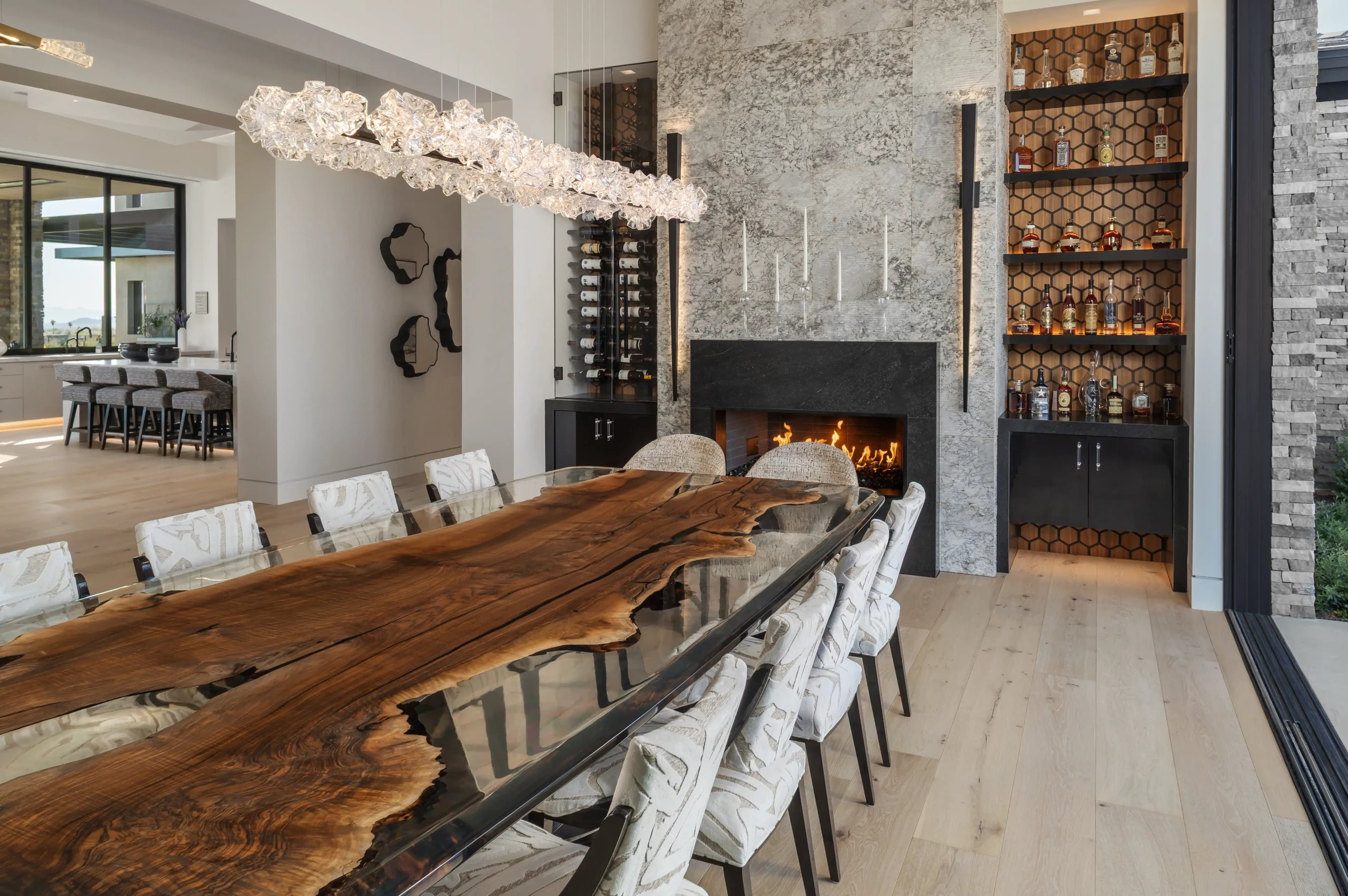 Evandros bespoke dining table with Anatolian walnut and translucent resin tabletop in a contemporary private residence.